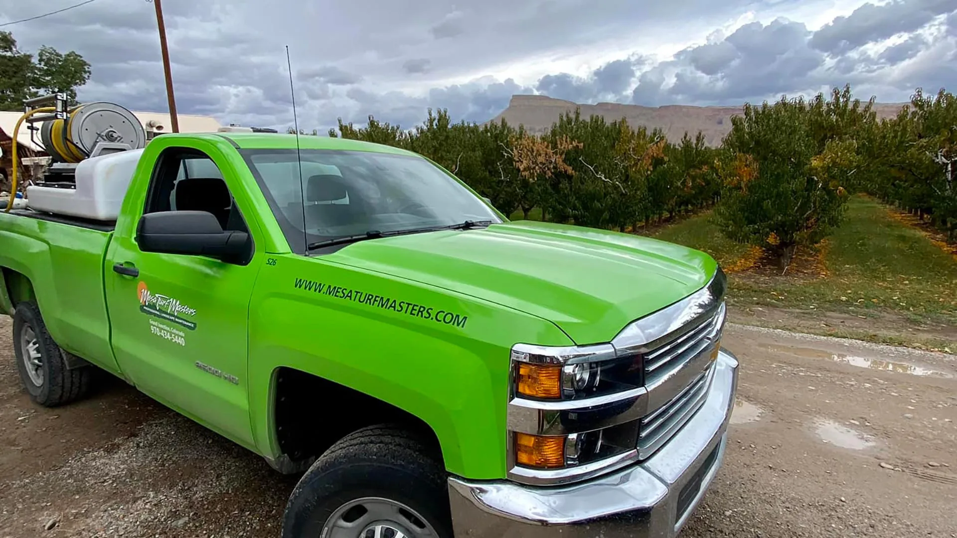 The Mesa Turf Masters work truck at a farm applying tree fertilizer in the Grand Junction Area.