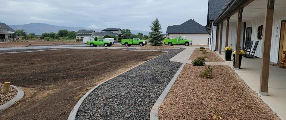 Mesa Turf Masters work trucks at a home with a new rock landscape bed in Grand Junction, CO.